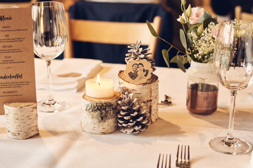 Tischdeko mit Menükarten und Kerzen im rustikalen Stil